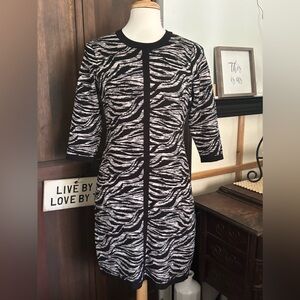 Animal print, sweater knit dress is sassy & hugs your curves beautifully! Sz L